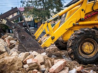 Bulldozer Loading Demolition Debris — Adrian’s Destruction Services In Molendinar, QLD